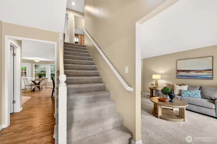 The foyer opens to a bright, easy flowing main level with refinished hardwood floors and fresh new carpet where you want comfort most. The central staircase sets up a practical layout with all bedrooms upstairs, and the spaces connect naturally for everyday living.