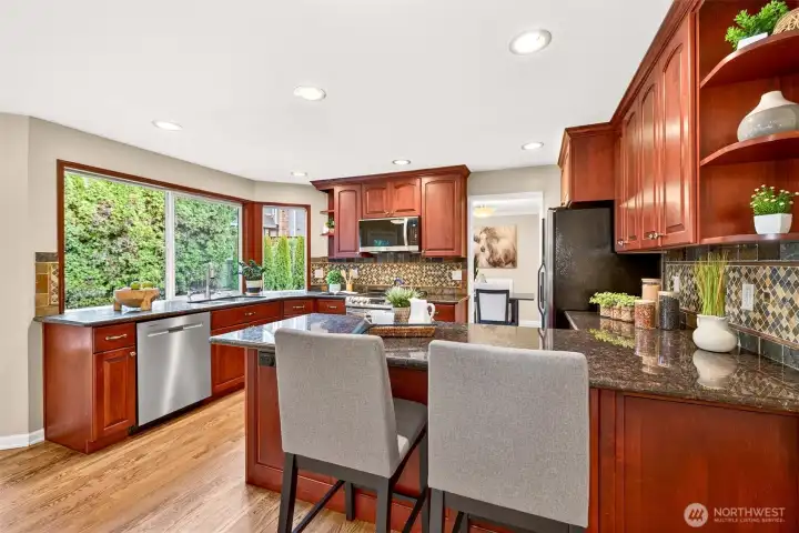 Generous breakfast bar and countertop space creates a natural gathering spot, with recessed lighting, stainless appliances, and an easy flow that keeps the cook connected to the rest of the main level.