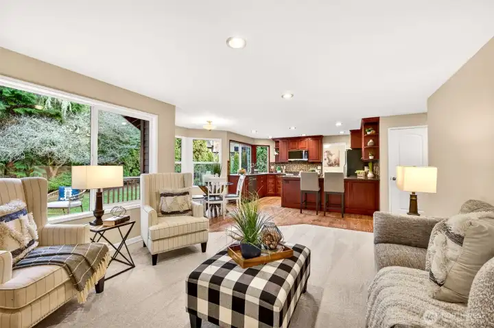 Great room feel with the kitchen, dining nook, and living area all connected, enhanced by abundant natural light and direct access to the deck and fenced yard.