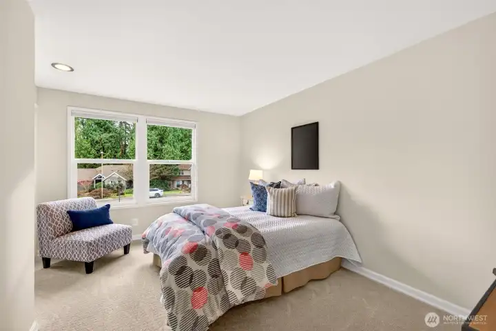 Another bedroom with a wide window wall and a simple, flexible layout that makes it easy to set up sleeping space plus a desk, or a reading corner.