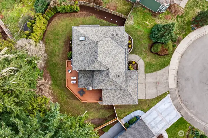 A true top down aerial view helps show the lot shape, deck placement, and how the home sits within the neighborhood. You can clearly see the outdoor living footprint and the separation from adjacent properties.
