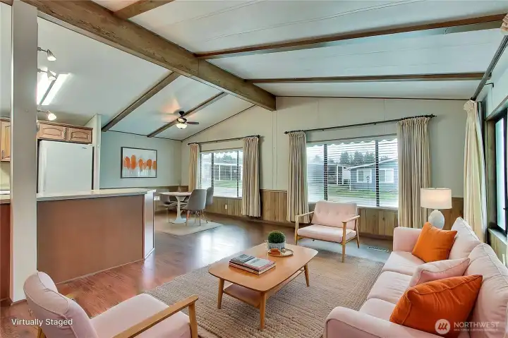 As you enter the home from the ramp side, you will find this big open living and dining area. Gorgeous flooring throughout, cathedral ceilings and large windows bringing in all the light. ***Virtually Staged***