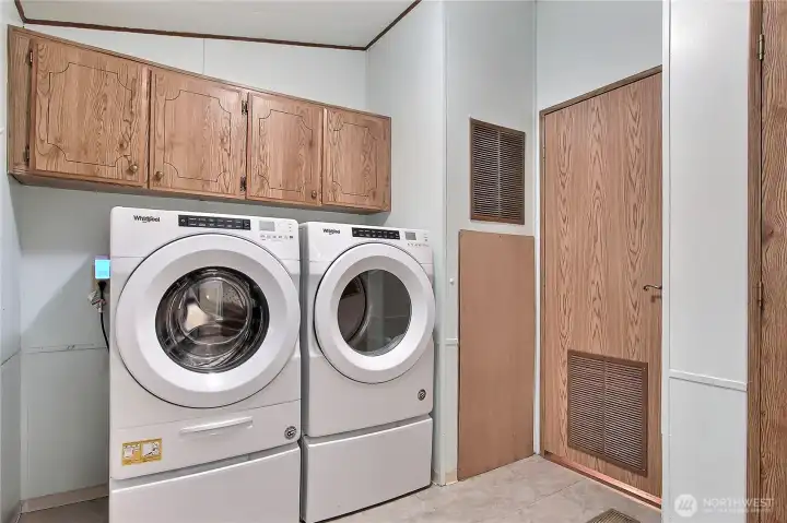 Really nice utility room off of the carport side, included washer and dryer with pedestals! I love the storage, and your water heater is located to the right of the washer and dryer, hall entrance to the right, full bath entrance to your far right.