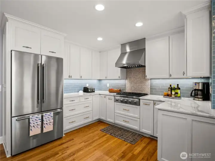 Quartz countertops crowns the white cabinetry.