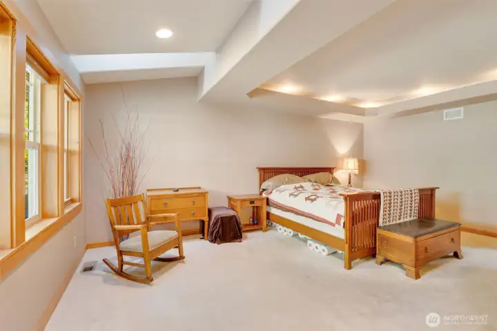 Primary with coffered ceilings and skylights above the windows