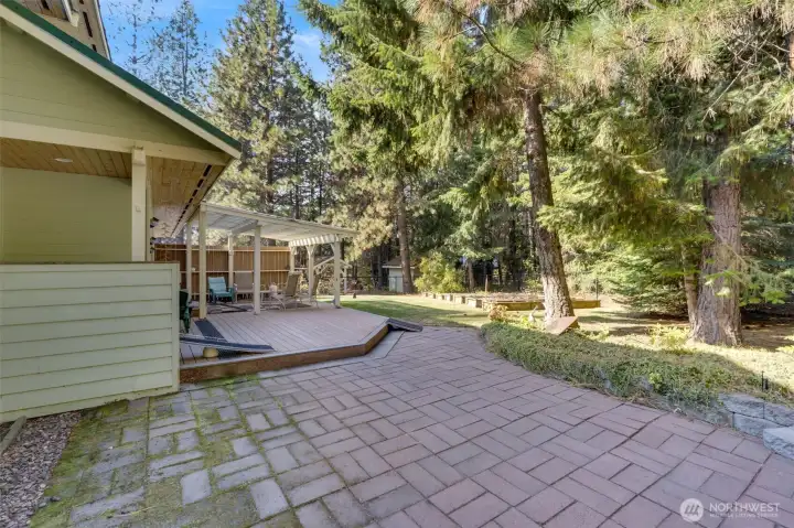 Patio space in backyard adjacent to the massive deck