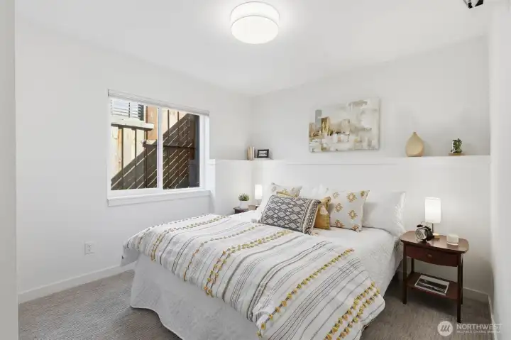 The 2nd bedroom on the main level views to the side yard and offers great privacy.