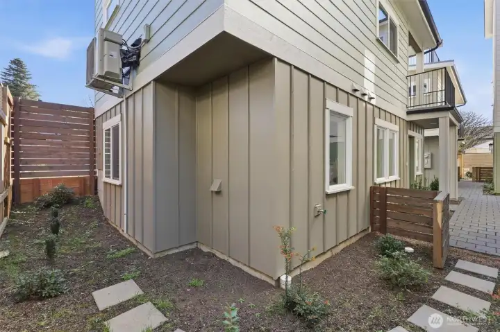A view of the gate leading from the front entry of the home to the side yard.