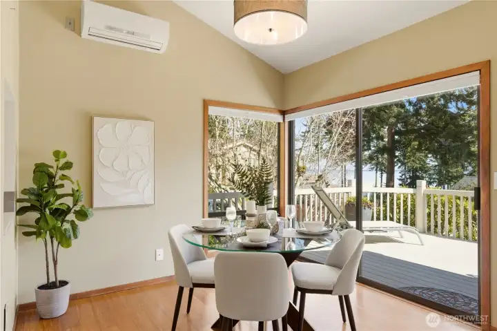 Enjoy meals in this wonderful space, looking out to the view! The vaulted ceiling of the dining room adds to its spacious feel. Shown on the wall is the mini-split, providing comfortable A/C during warmer months.