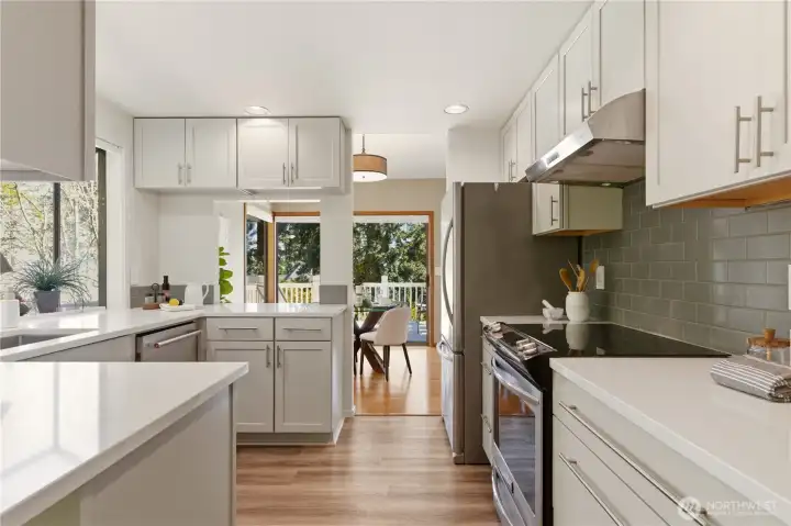 A modern kitchen awaits the home chef, with quartz countertops, soft-close cabinets, and stainless appliances.