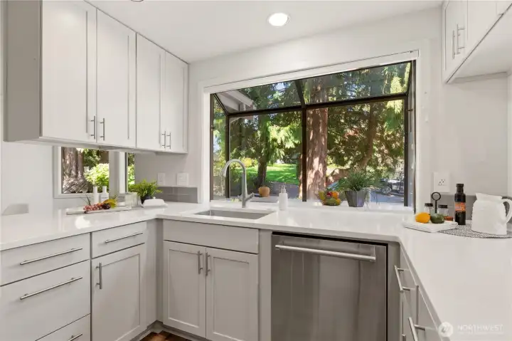 The garden window over the kitchen sink provides space for favorite plants, and warms the kitchen with natural light!