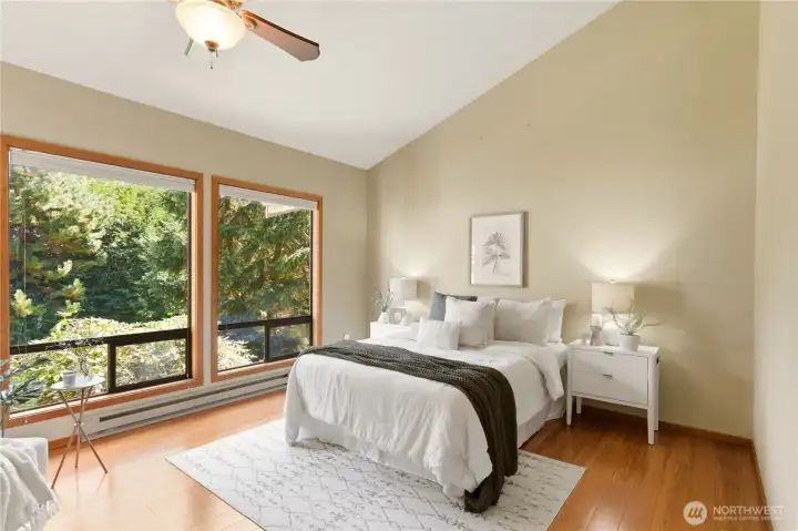 Large enough for a furniture ensemble, the primary suite is a quiet retreat. The vaulted ceiling provides a spacious and roomy feel. There are views of the Puget Sound from this room too!