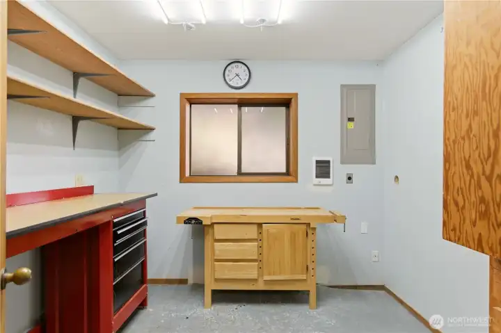 Another delightful discovery of the lower level is this workshop / hobby room. It features a tool chest and great countertop space for creating!