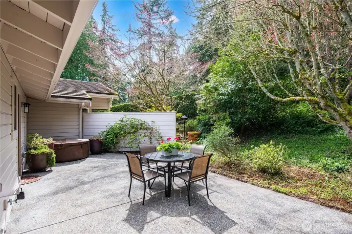 Behind the home you'll find this spacious patio, a quiet and private oasis, where you can enjoy meals al fresco or unwind in a favorite outdoor recliner.