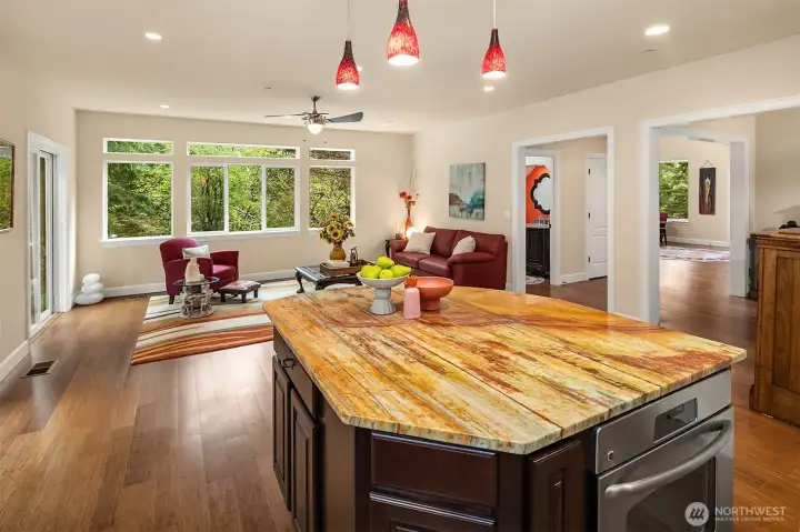 Open to the family room and surrounded by walls of windows with only nature in sight