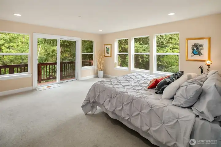 The primary bedroom feels like sleeping in a treehouse.  The sound of the waterfall and the breeze it creates will make your sleepless nights a thing of the past.  The deck looks out over the bridge, waterfall and pergola.