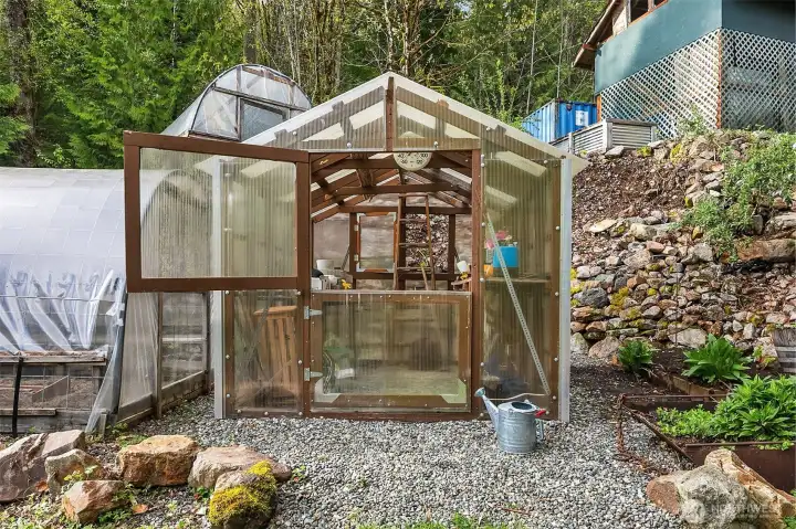 Every gardener's dream is on this property --- great sun, greenhouse, hot house, hoop house -- raised beds, storage and carport for equiment.