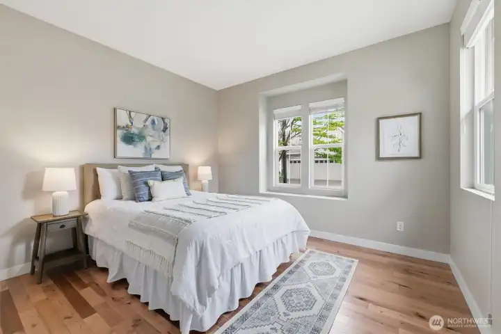 The second bedroom is ideally located at the other end of the home from the primary suite. Enjoy beautiful hardwood floors in this room as well and the adjacent full bathroom makes it an ideal space for guests. The second bedroom is ideally located at the other end of the home from the primary suite. Enjoy beautiful hardwood floors in this room as well and the adjacent full bathroom makes it an ideal space for guests.