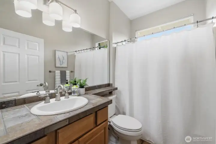This is the aforementioned full bathroom that is conveniently located adjacent to the home's second bedroom. This is the aforementioned full bathroom that is conveniently located adjacent to the home's second bedroom.