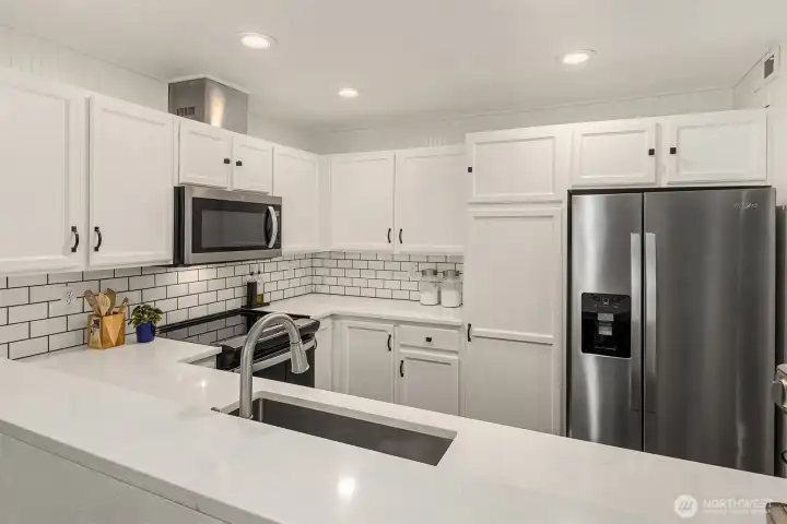 Looking from the dining area towards the kitchen with plenty of counter and cabinet space.