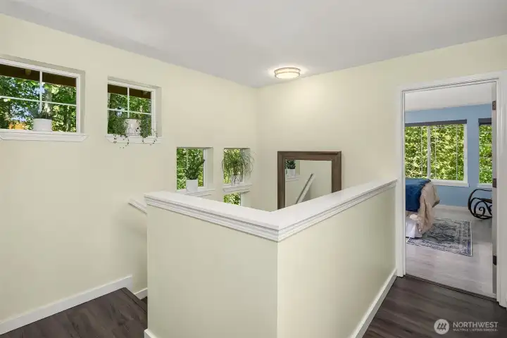 We just headed up the stairs - enjoying even more windows - and arrive at this landing. The upper level features the three bedrooms and two full baths.
