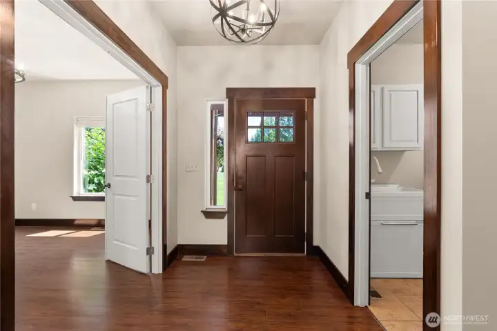 Entry with Den/Office to the left. Right leads to laundry room and garage access.