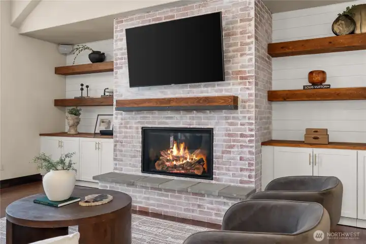 Custom hearth, new heating rated fireplace and built-in cabinets and shelving.