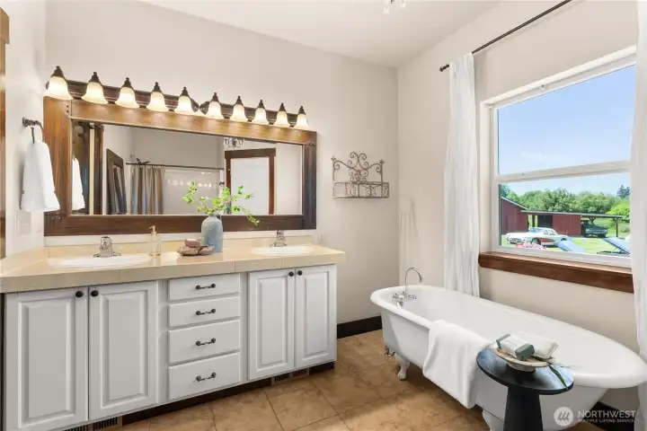 Primary 5 piece En-suite features vintage soaking tub.