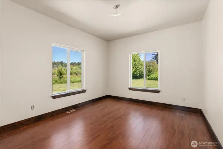 Bedroom 2. All bedrooms feature hardwood floors.