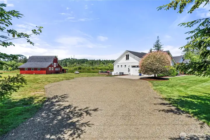 Spacious 2 car garage and newly added carport and storage in the barn.