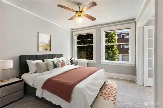 Beautiful virtually staged bedroom off great room big enough for all your furnishing including room to make an office also.  Even more windows to add lots of light year around when you live here.  Large ceiling fan and light keep you cool and warm