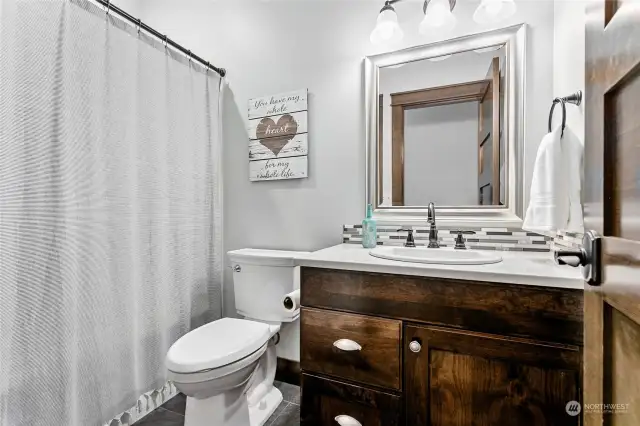 Full bath for guests & 2nd downstairs bdrm. Also has own linen closet behind door to right