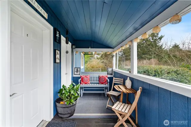 Cute covered front porch with entrance to home & 2nd entrance to laundry room