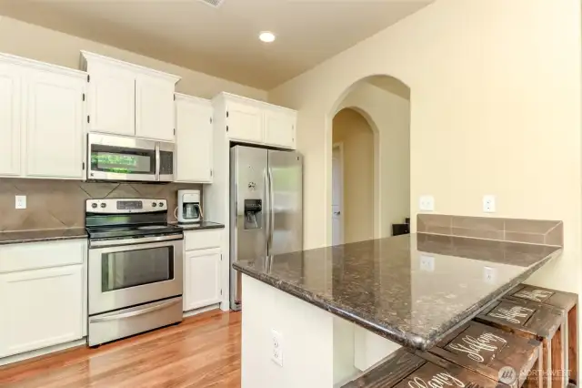 Plenty of space for meal prep with an eat in bar.