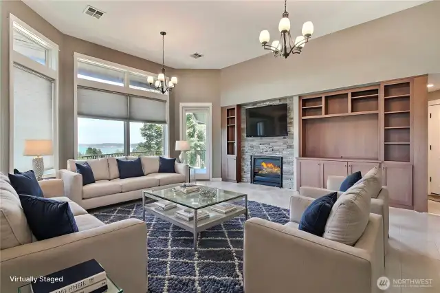 Behind the entry wall you will find this spacious family room with large windows, gorgeous fireplace and quality built-ins. Door leads to balcony porch, come in and relax! ***Virtually Staged***