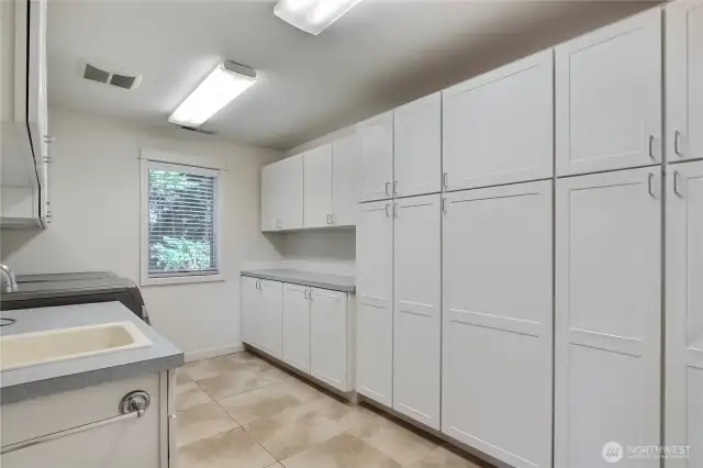 Downstairs you will also find this ENORMOUS utility room with handy sink and look at all that storage!