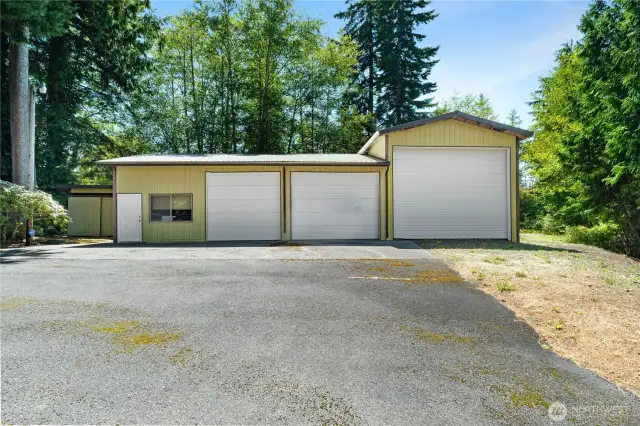 Huge 3-Bay shop with tall RV door, 2 Bays have cement floors, there's also an Office, 1/2 Bathroom, and Loft for extra storage.
