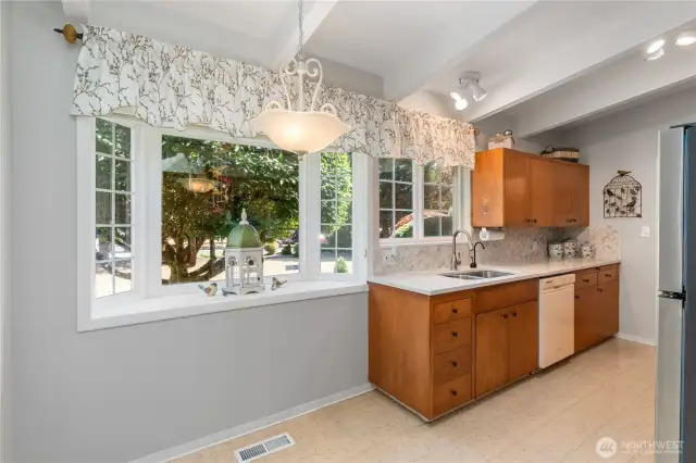 The natural light streams into this beautiful kitchen, with room for table.