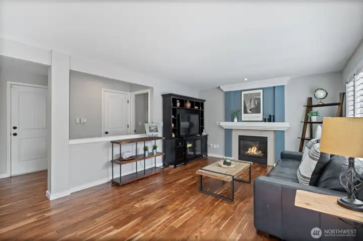 Cozy gas fireplace! View is looking toward powder room and laundry room.