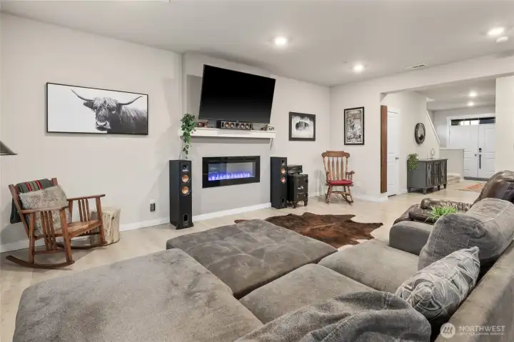 Living area with electric fireplace/ large windows for natural light