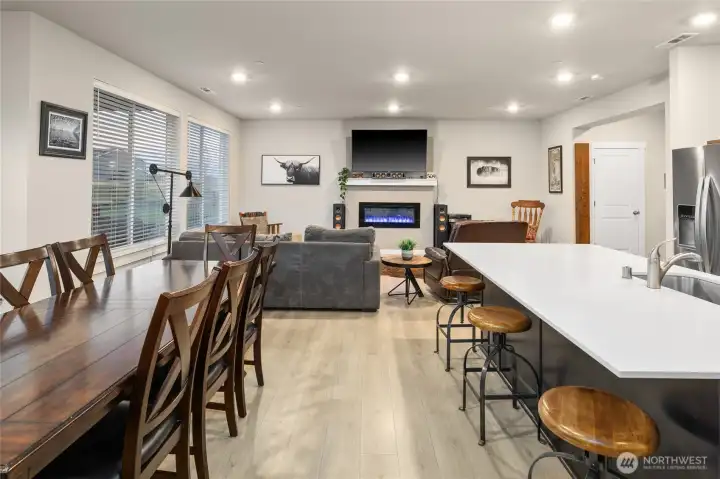 Well- maintained Palomino Home open concept chef's kitchen with quartz counters, Stainless steel appliances and soft-close cabinetry/great room/dining area