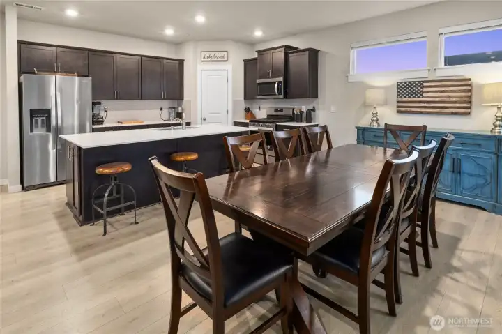 Well- maintained Palomino Home open concept chef's kitchen with quartz counters, Stainless steel appliances and soft-close cabinetry/great room/dining area