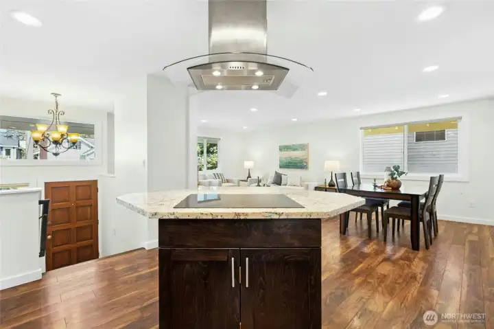 Renovated island kitchen opens onto living & dining areas.