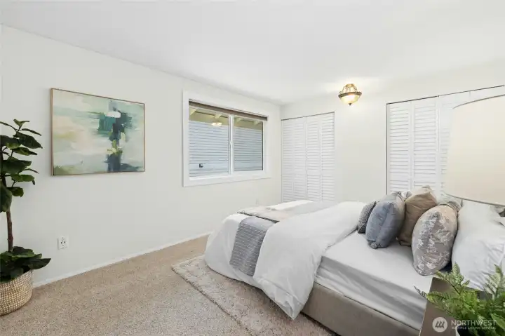 Primary bedroom with dual closets and continental bath.