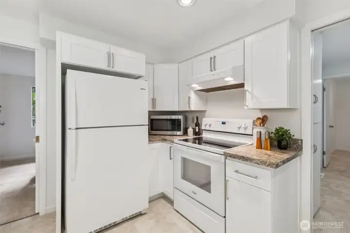 The modern range and sleek hood complement the clean design. It’s a kitchen you’ll love to use and be proud to show off. New, vinyl flooring for a fresh, cohesive look.