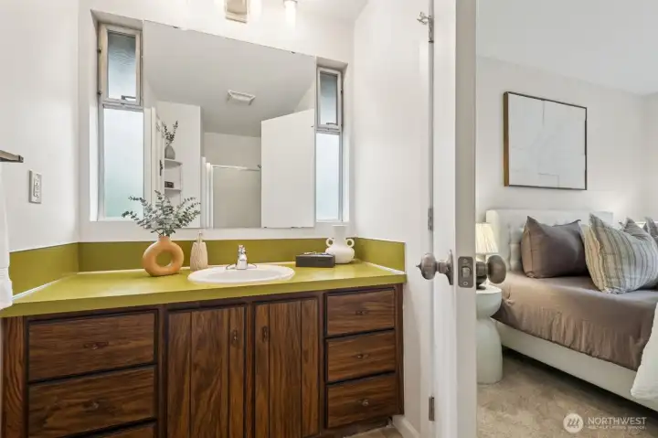 The Primary En Suite offers a walk in shower and large cabinetry with lots of room for your personal toiletries.