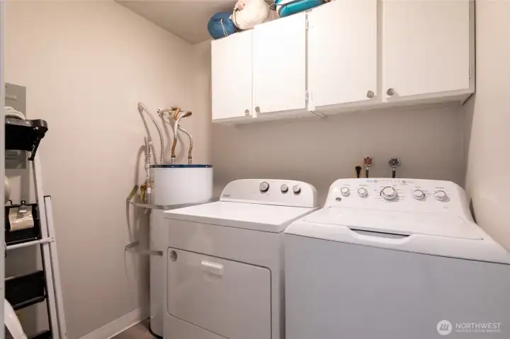 Convenient laundry room with brand-new washer and dryer.