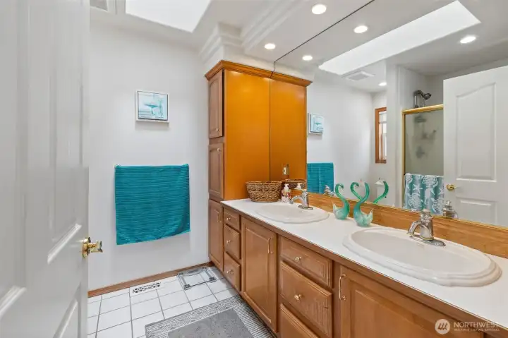 Primary bath with large walk in shower and double sinks. Plenty of cabinet space too.