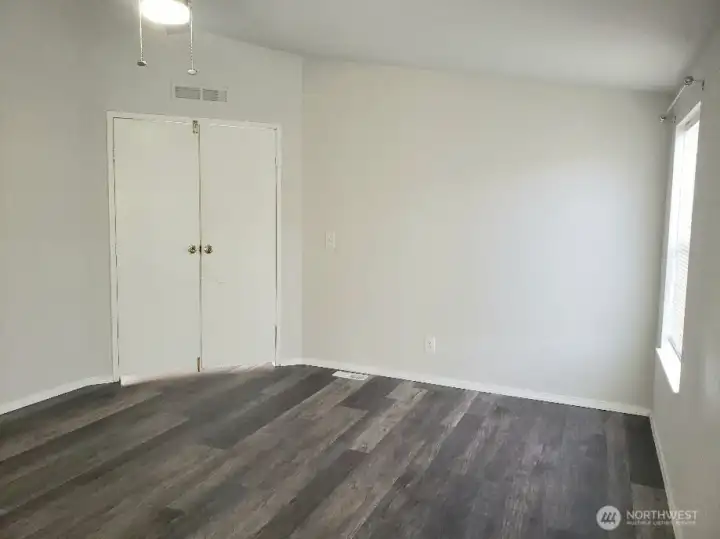 Picture of the Huge Primary Master Bedroom with Double Entry Doors Newer Trim, and Vinyl Plank Flooring.