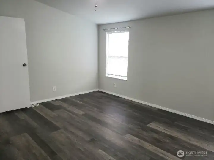 Picture of the Huge Primary Master Bedroom with Double Entry Doors Newer Trim, and Vinyl Plank Flooring.